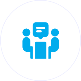 Two people discussing at a table icon.